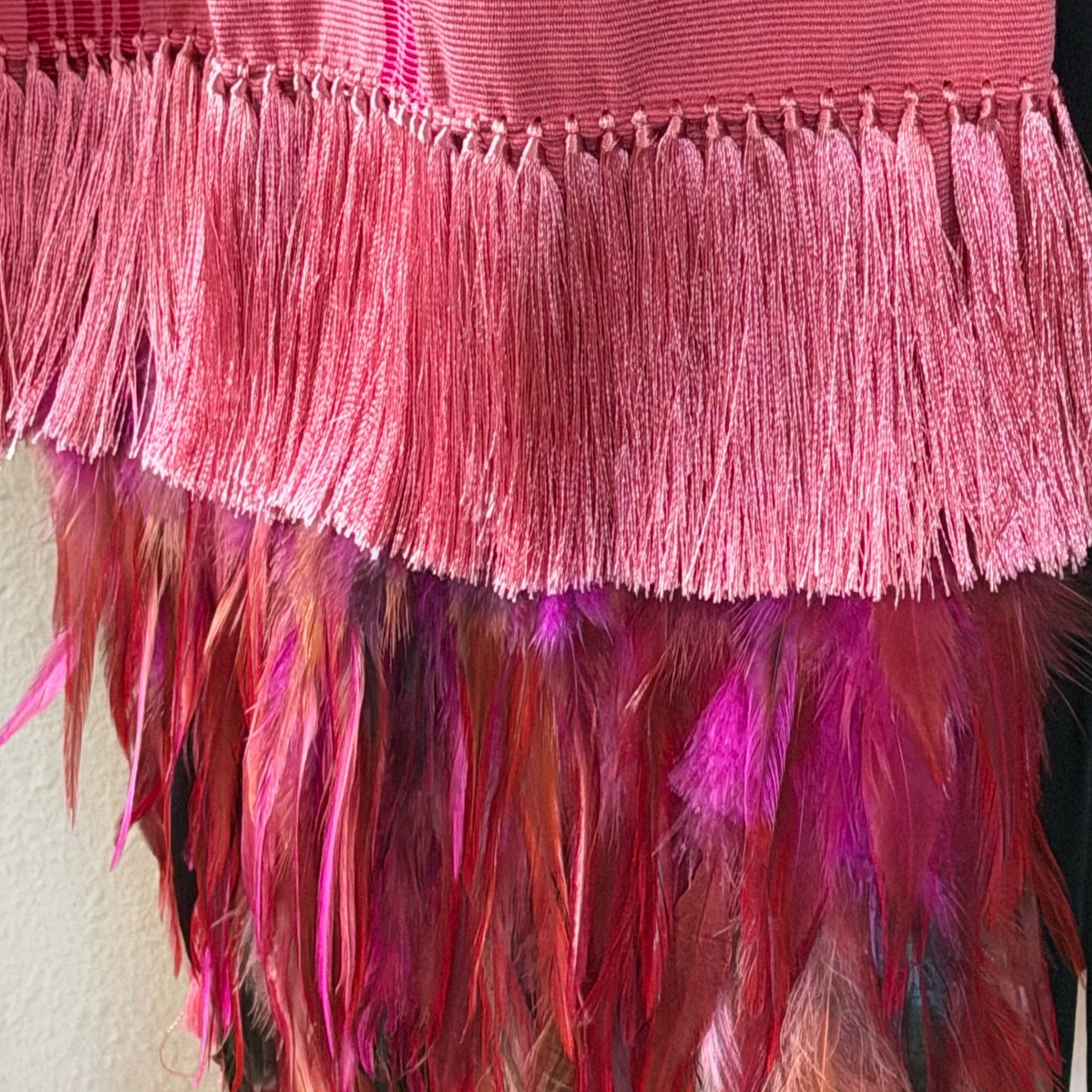Overhead flat-lay of Purepecha rebozo showing full stripe pattern, silk fringe, and feather details