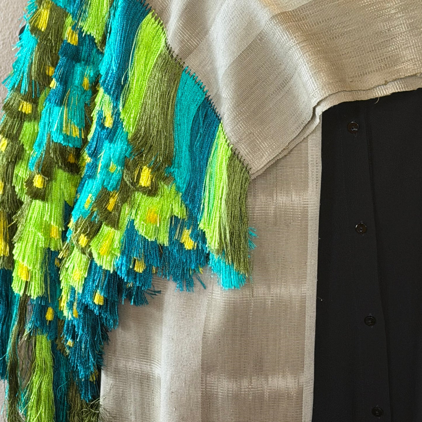 Full length view of Purepecha ikat shawl draped, showing stripe composition and silk fringe detail
