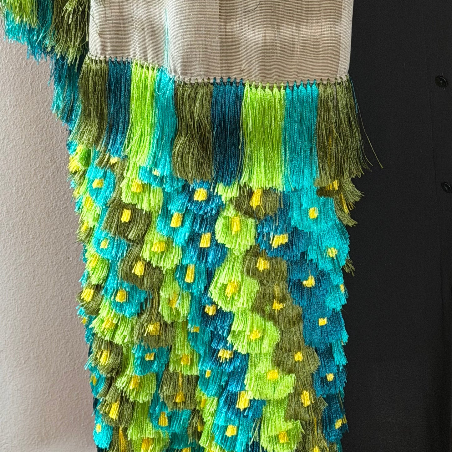 Close-up of ikat pattern on Purepecha backstrap loom rebozo showing precise pre-dyed thread alignment