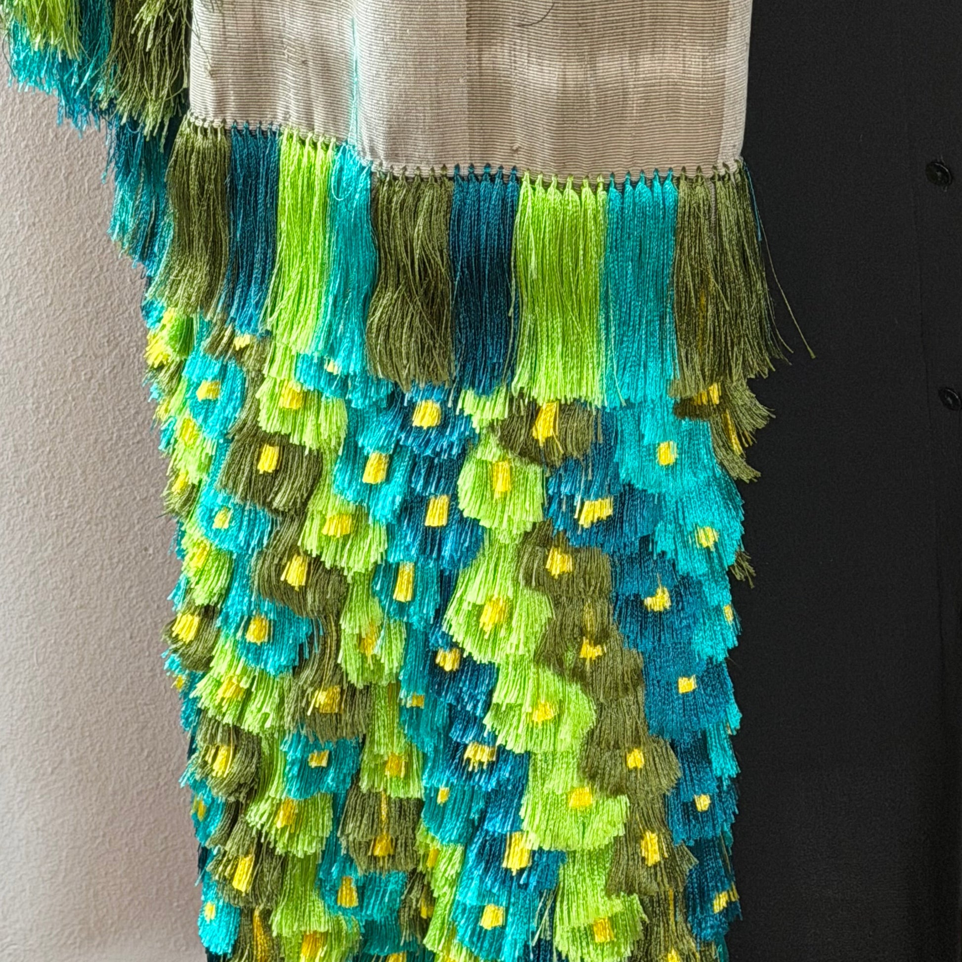 Close-up of ikat pattern on Purepecha backstrap loom rebozo showing precise pre-dyed thread alignment