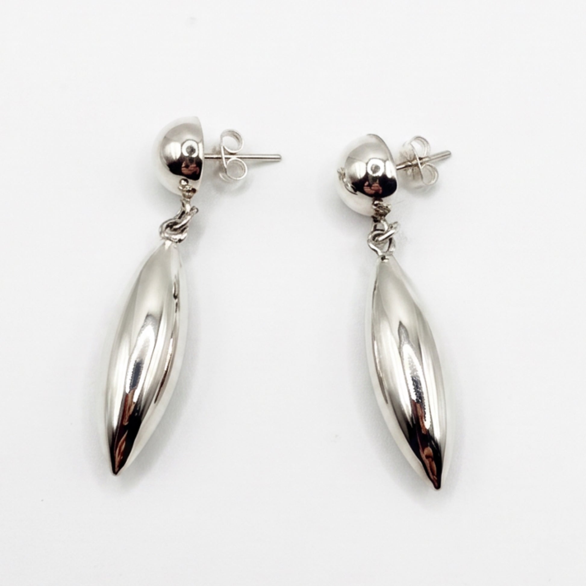 A pair of polished silver drop earrings with teardrop-shaped dangling pendants and butterfly backings, shown on a plain white background.