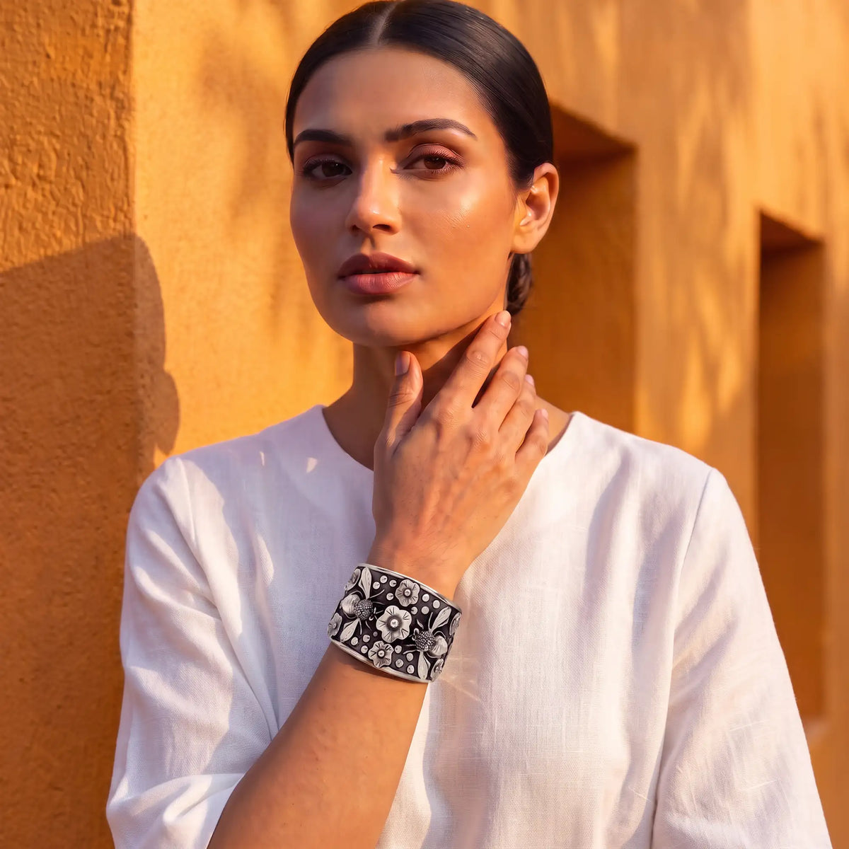 Black and white floral cuff bracelet with intricate silver detailing.
