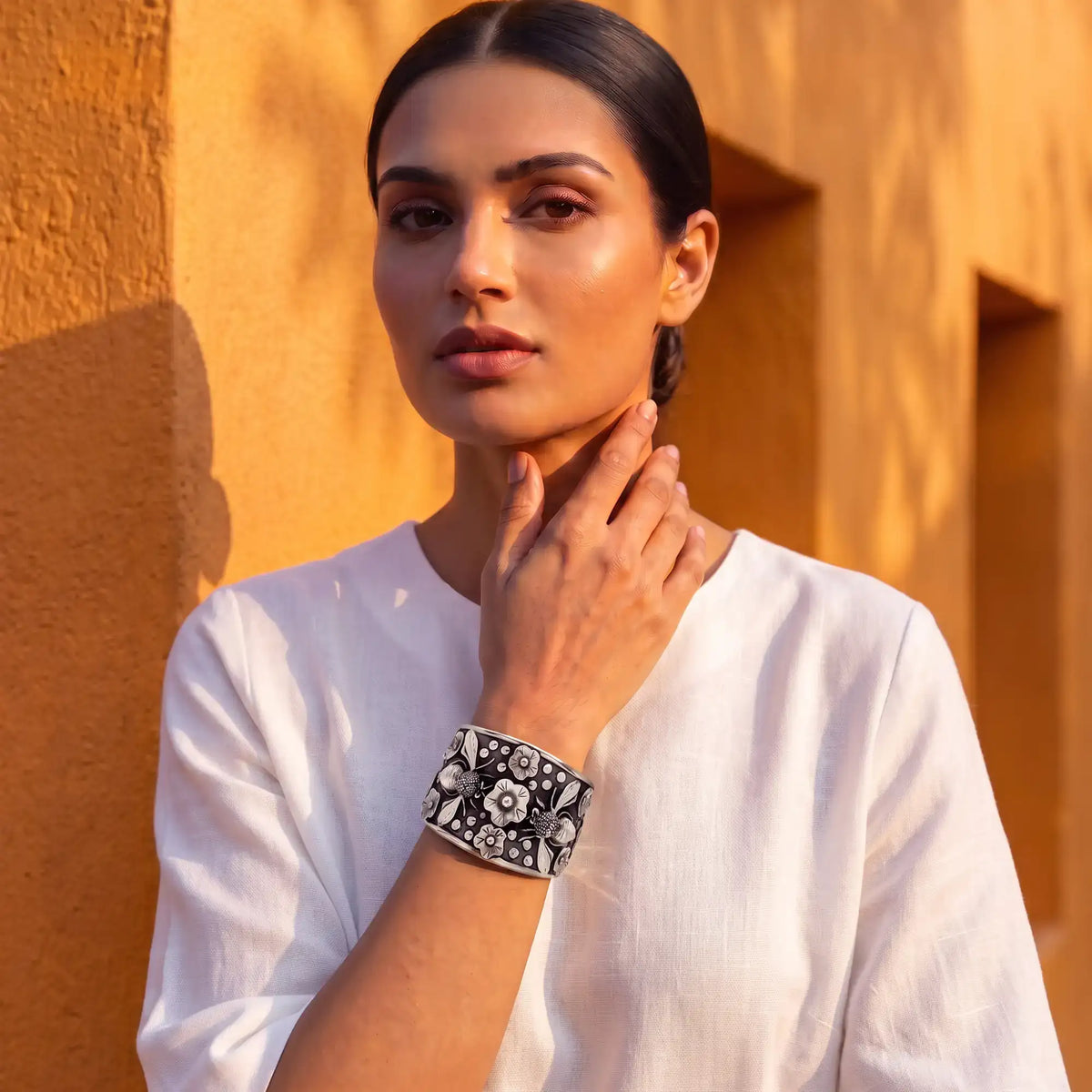Black and white floral cuff bracelet with intricate silver detailing.