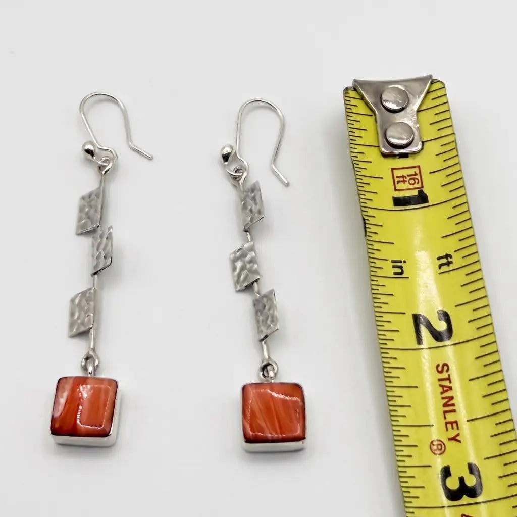 Long silver Taxco dangle earrings with a coral stone