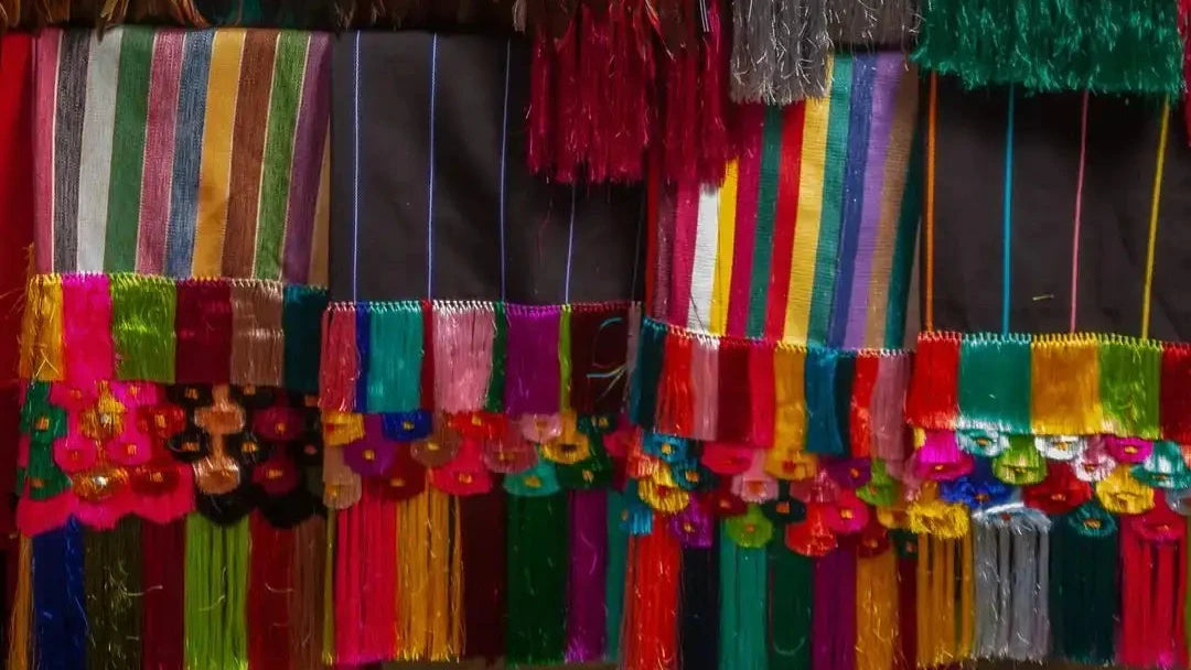 Multicolored silk scarf with tassels and floral accents.