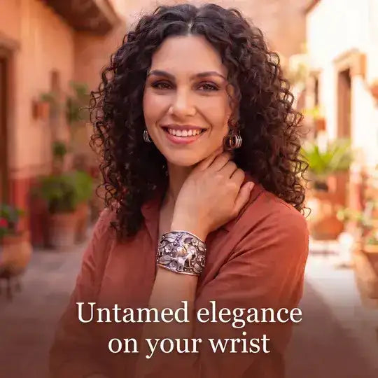 Silver-toned, intricately engraved cuff bracelet with a bold, ornate design.