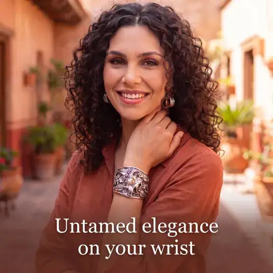 Silver-toned, intricately engraved cuff bracelet with a bold, ornate design.