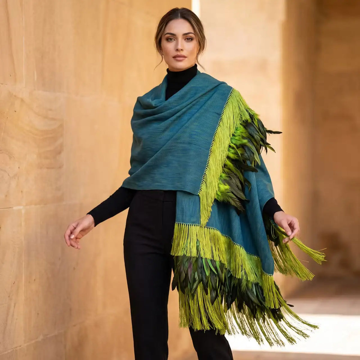 Teal wool shawl with layered green leaf fringe.